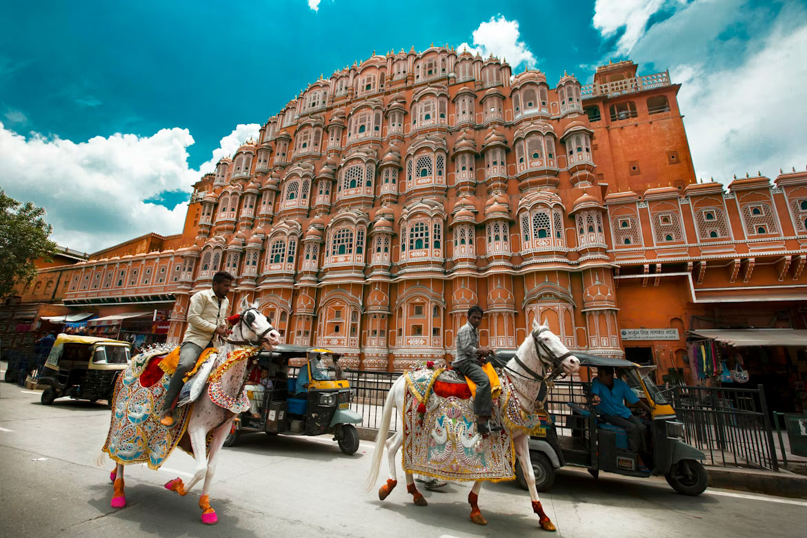 People walking in front of Hawa Mahal Jaipur Rajasthan India street view